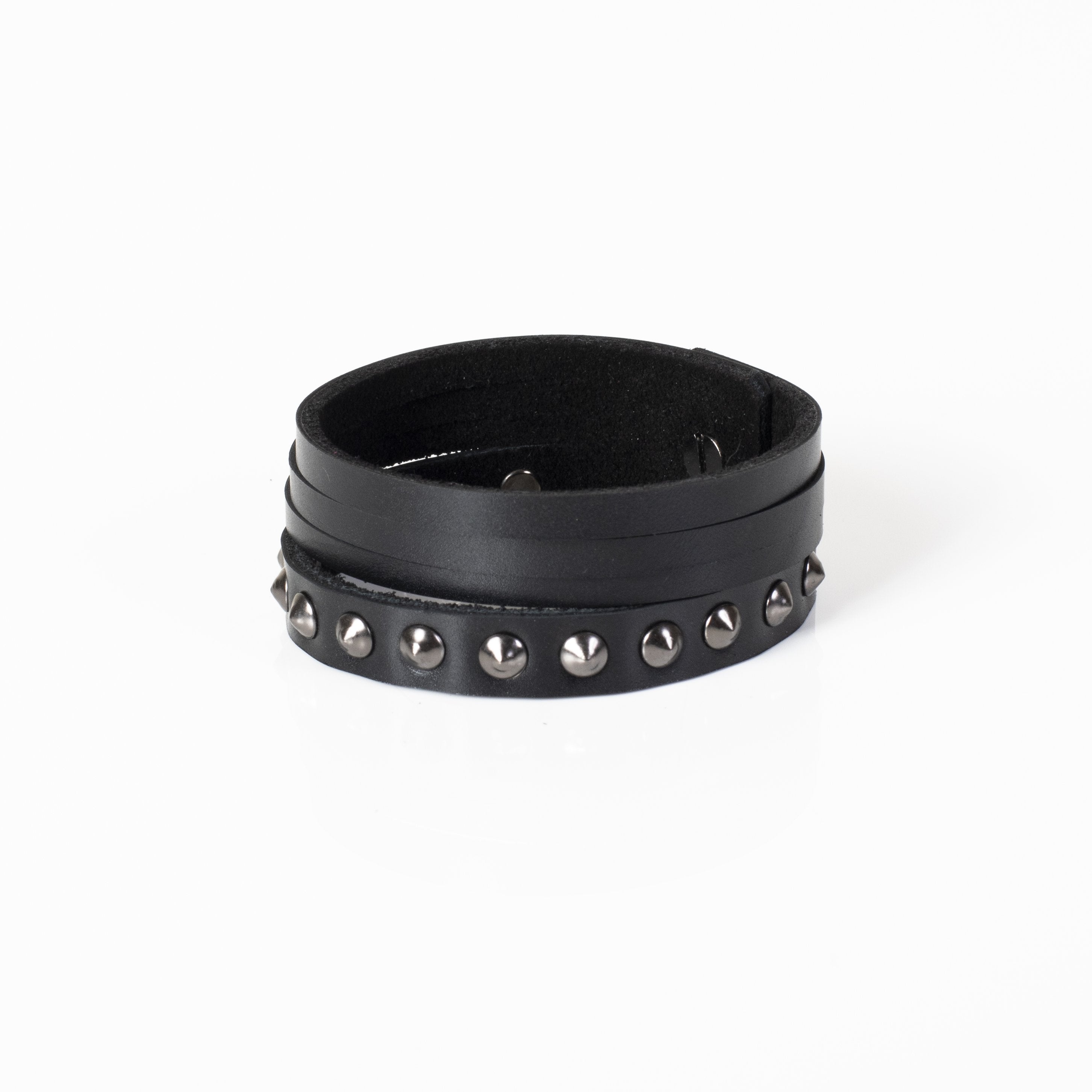 Men's multi-layer black genuine leather bracelet featuring gunmetal rivets, studded detailing, and adjustable snap-button closure on a white background.