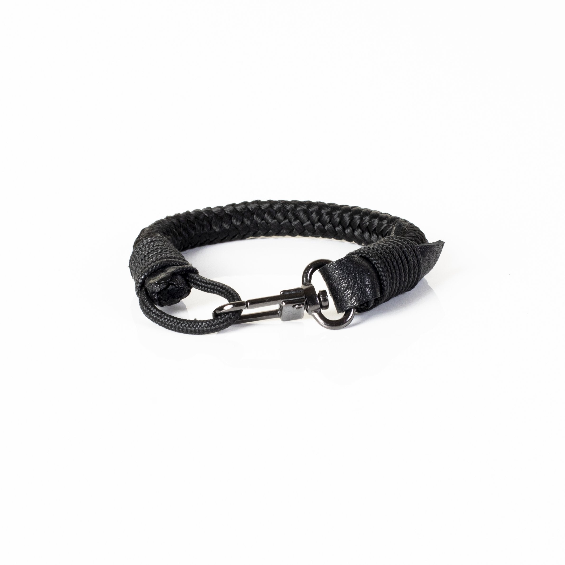 Handcrafted black braided leather bracelet with polished metal clasp displayed on a white background.