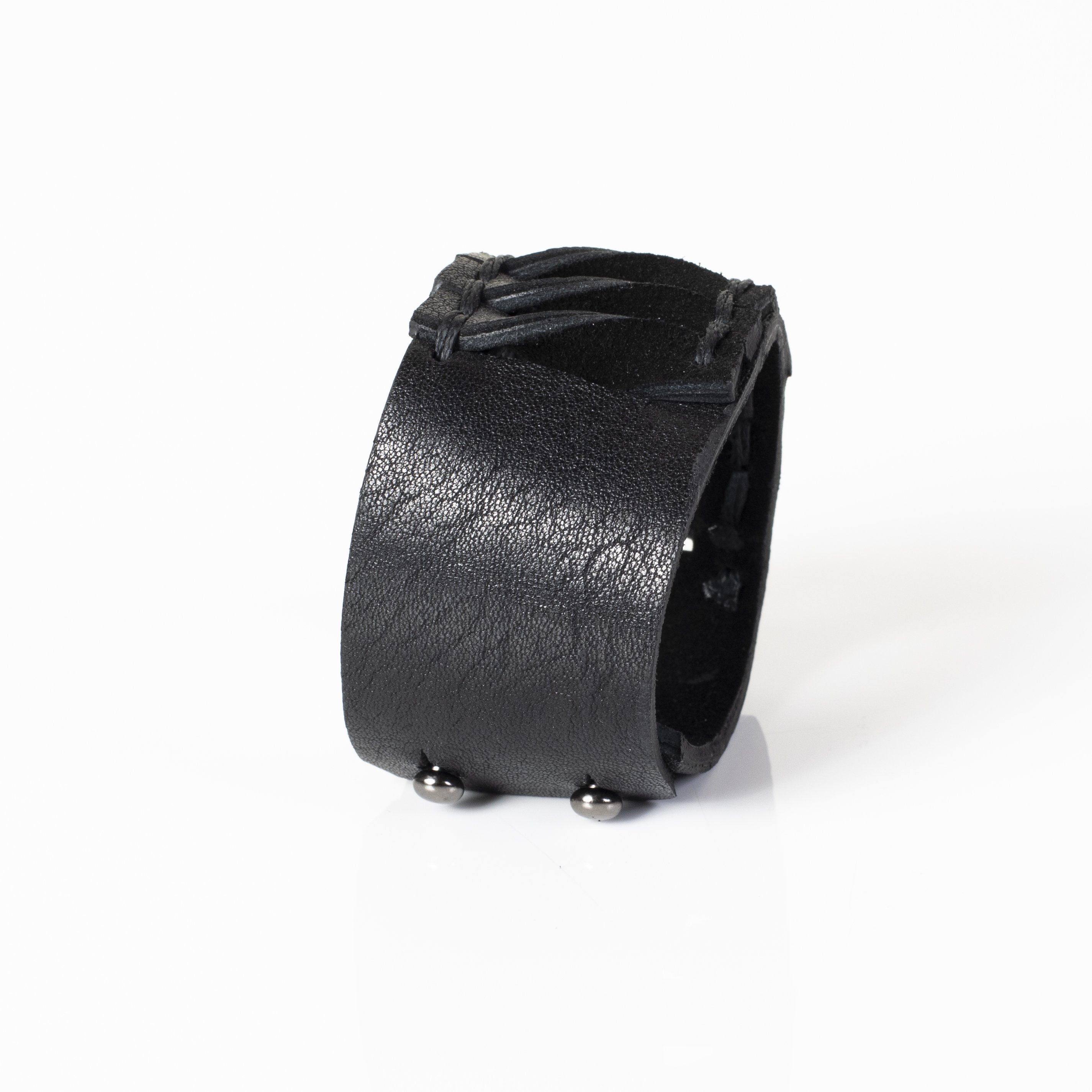 Handmade black leather cuff bracelet featuring lace-up detailing and faceted black crystals in a gothic statement design for men.