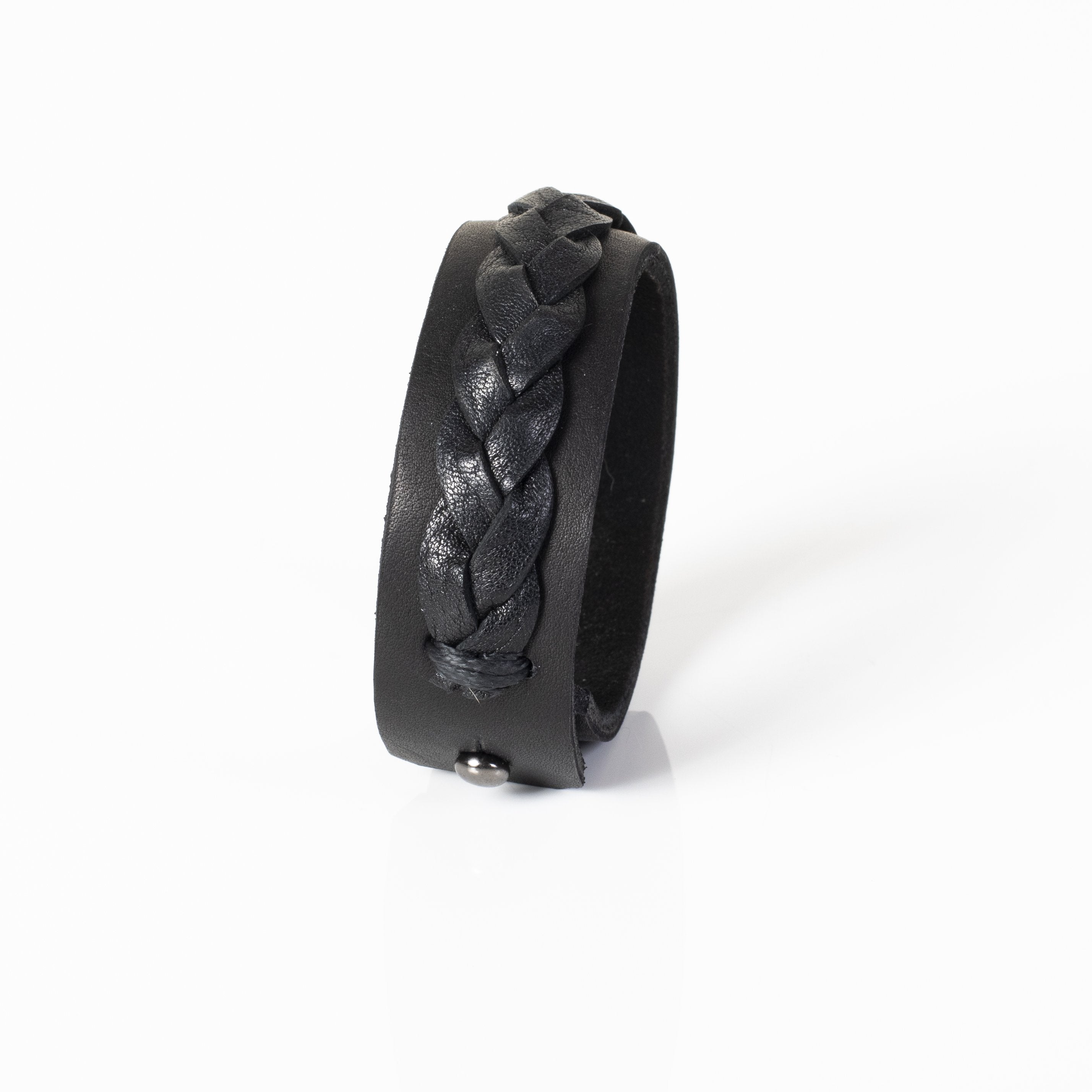 Handmade black leather cuff bracelet featuring a raised braided leather detail on a wide leather band.
