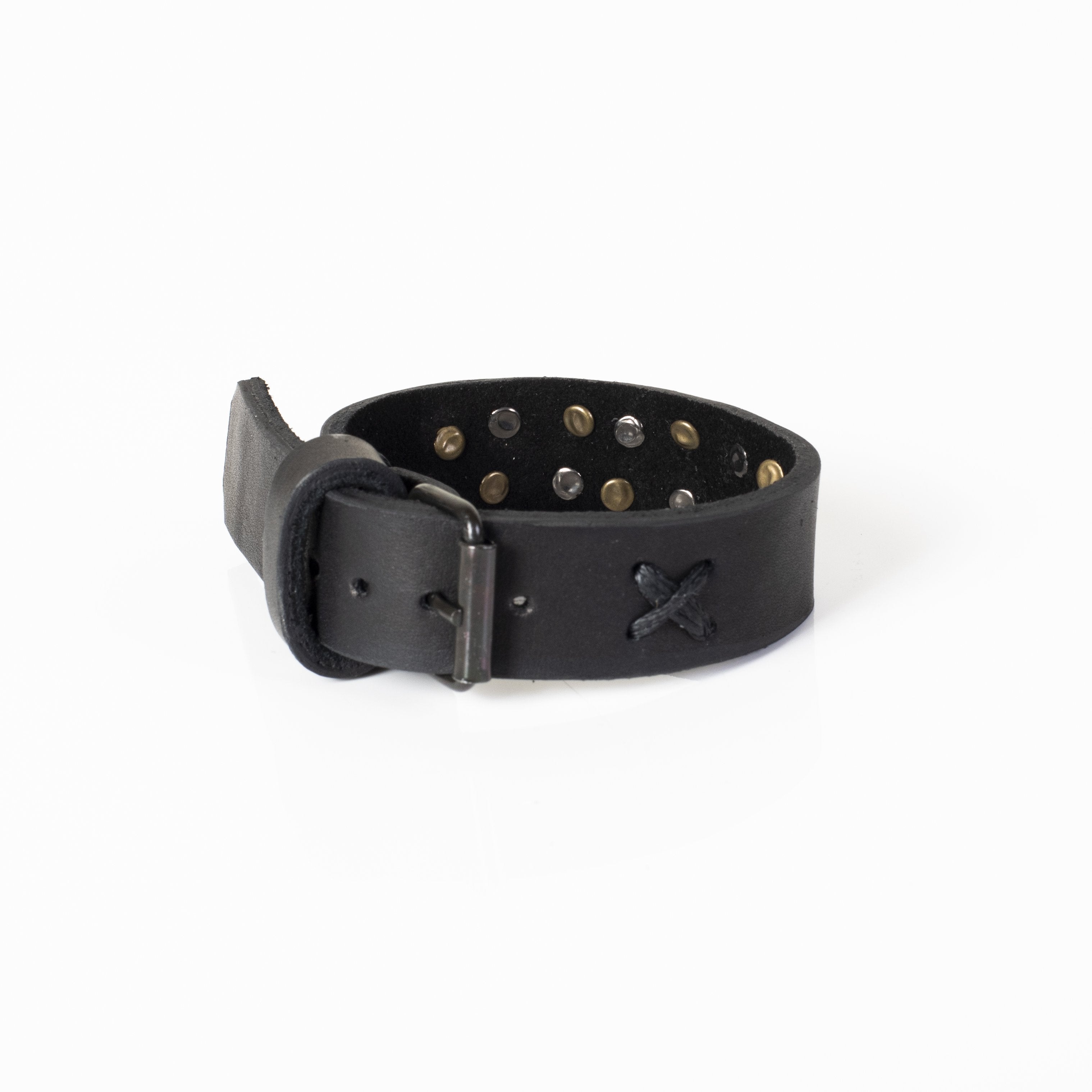 Handmade black leather cuff bracelet featuring antique brass and gunmetal studs with a wide statement design.