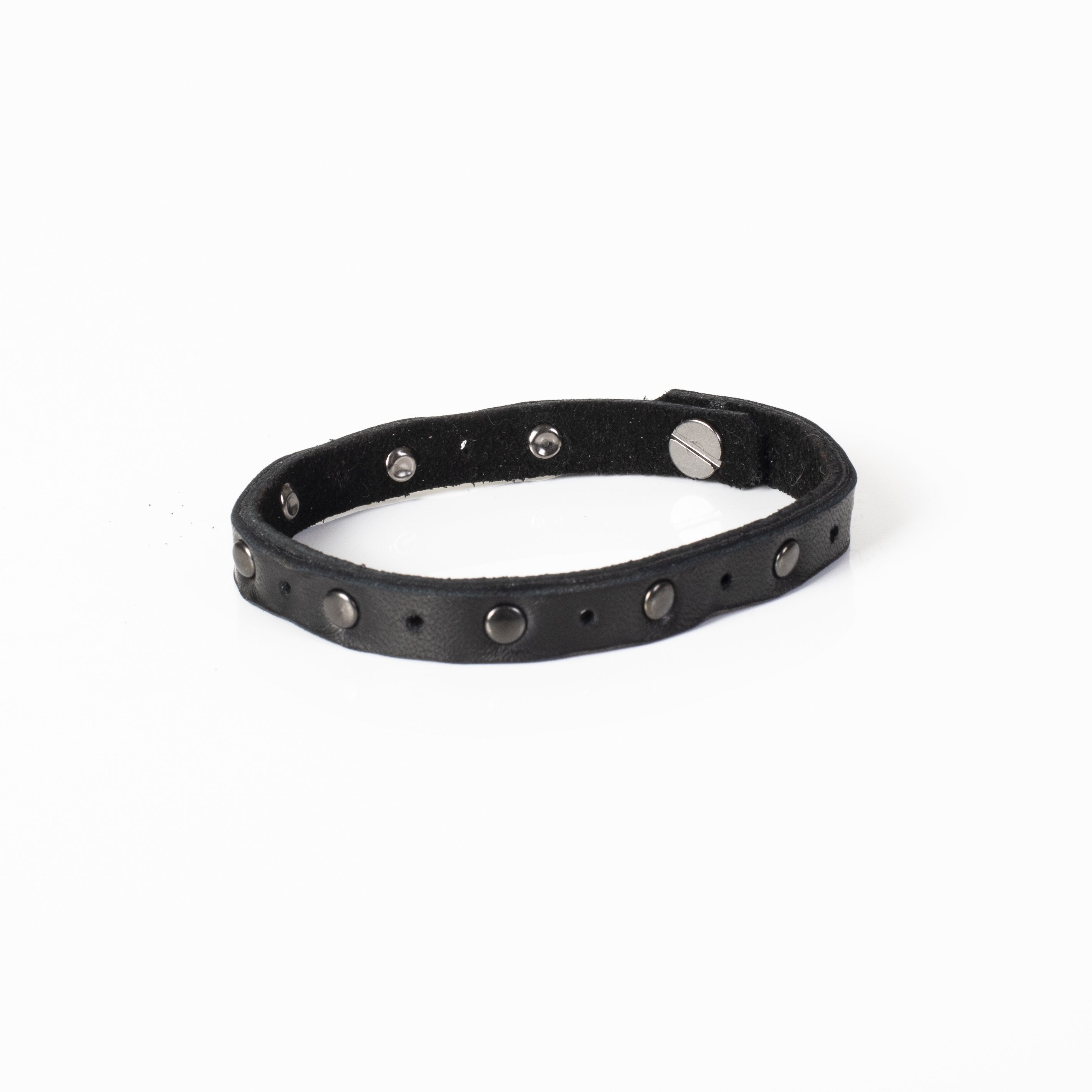 Handmade slim black leather bracelet featuring matte gunmetal studs and a secure snap closure.
