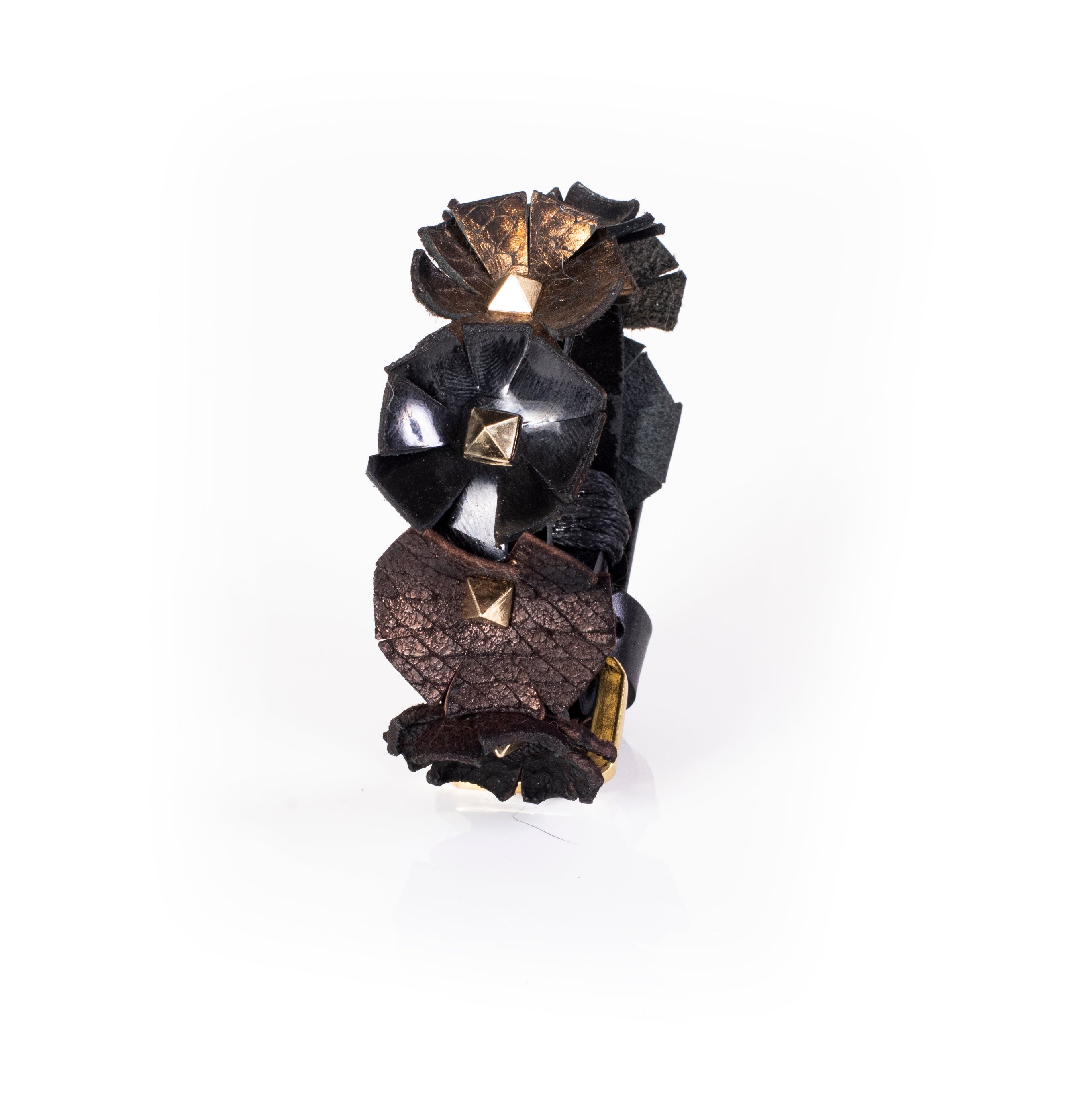 Black leather cuff with sculpted floral elements and gold pyramid studs