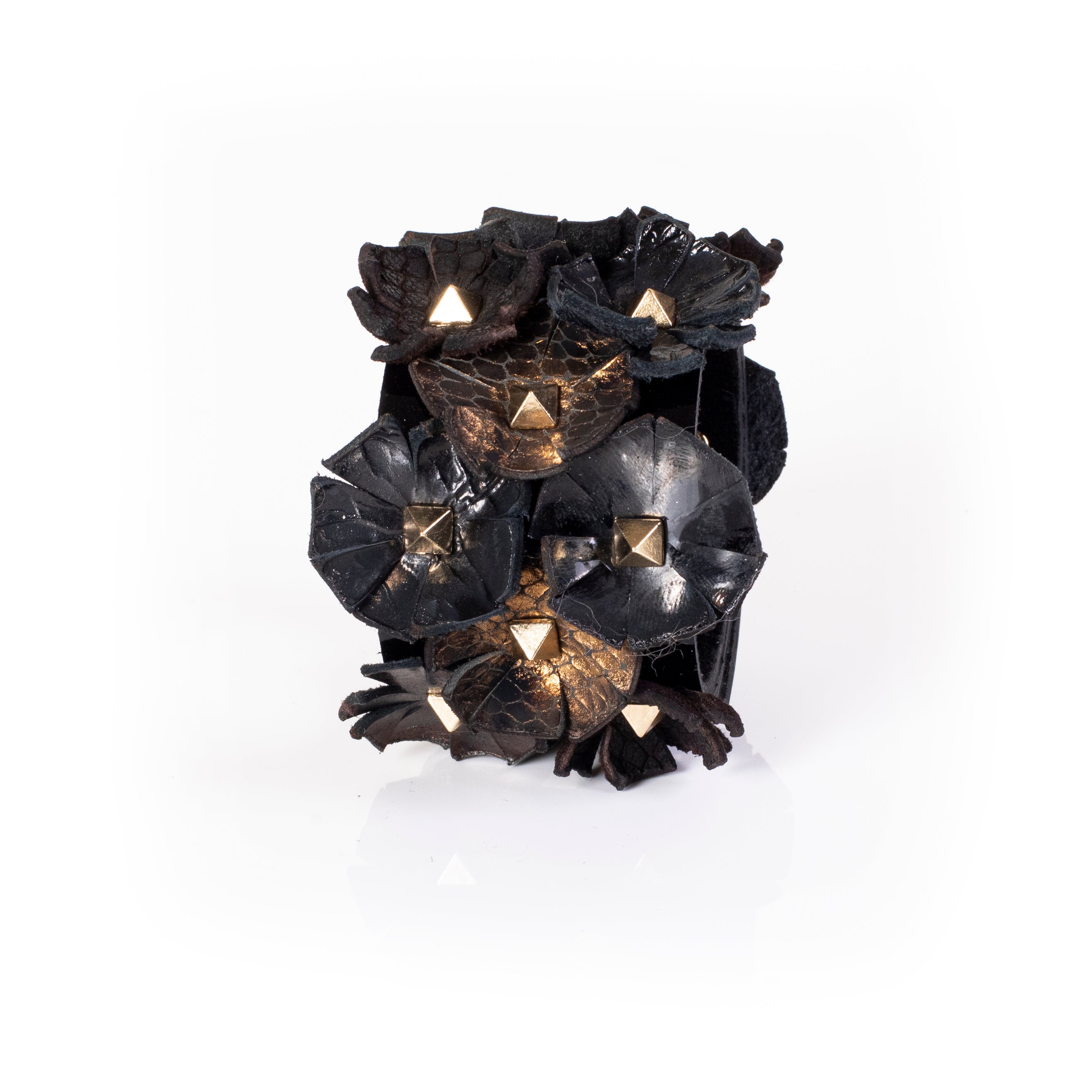 Black leather cuff with multiple sculpted floral elements and gold pyramid studs