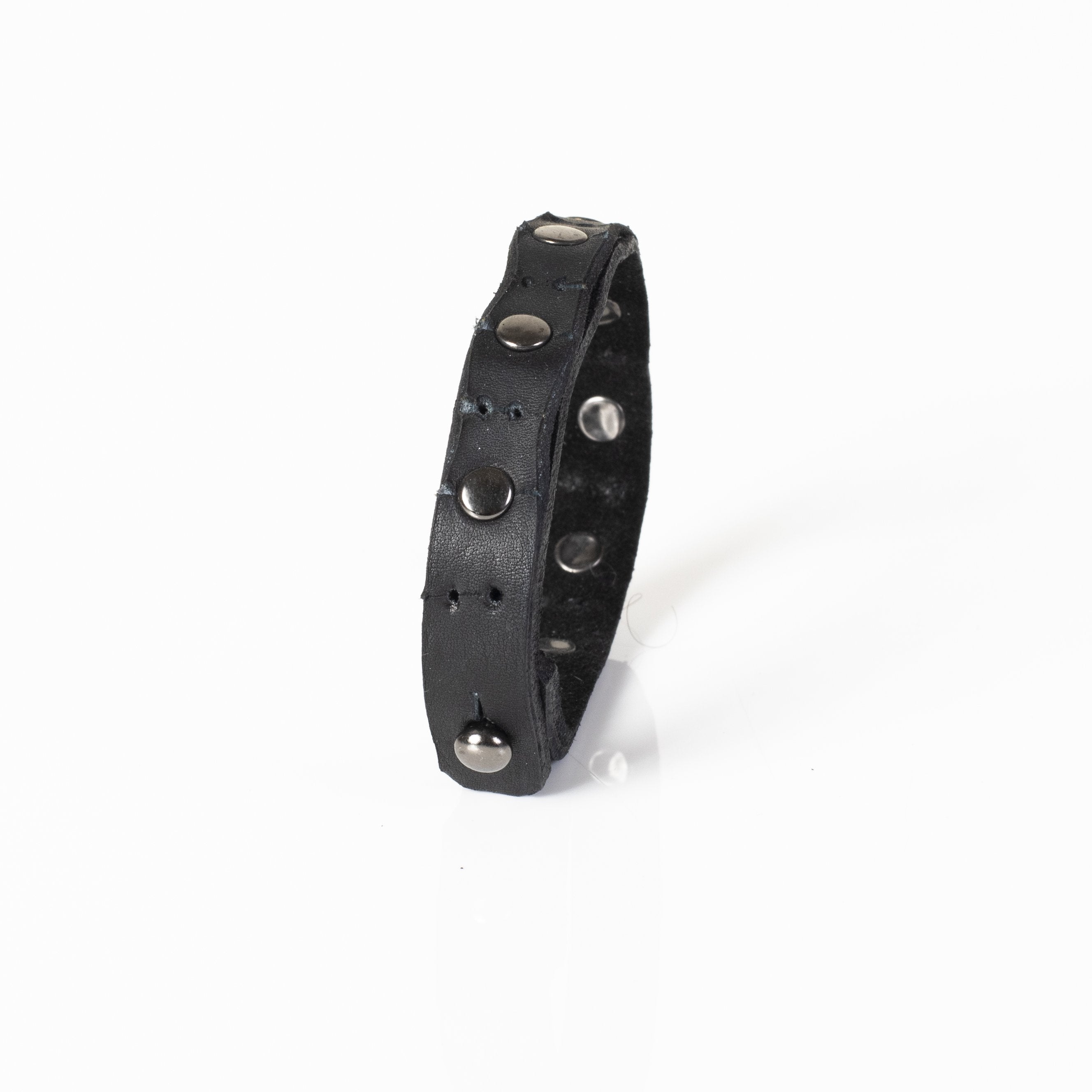 Handmade black leather bracelet featuring polished metal studs and an adjustable snap closure.