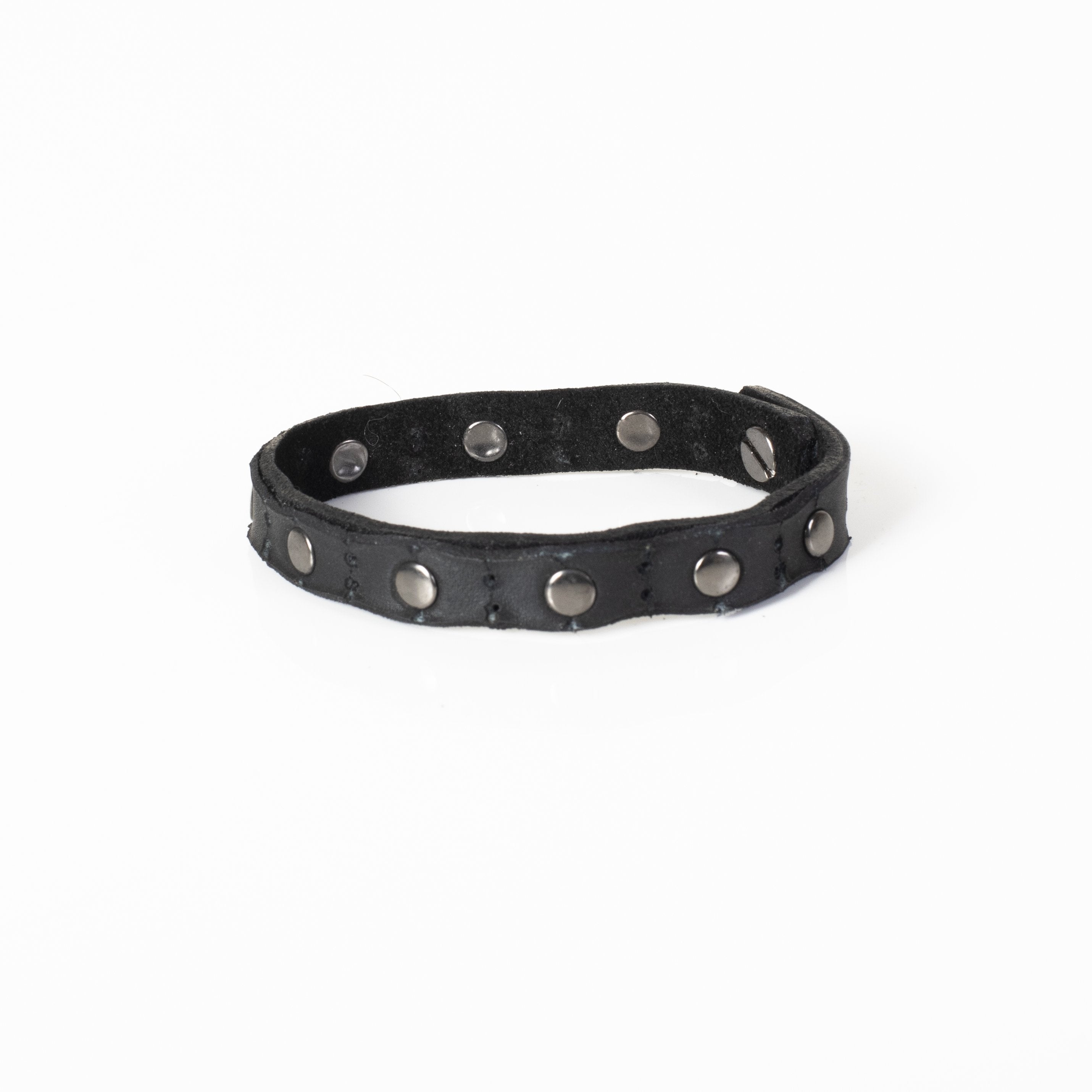 Handmade black leather bracelet featuring polished metal studs and an adjustable snap closure.