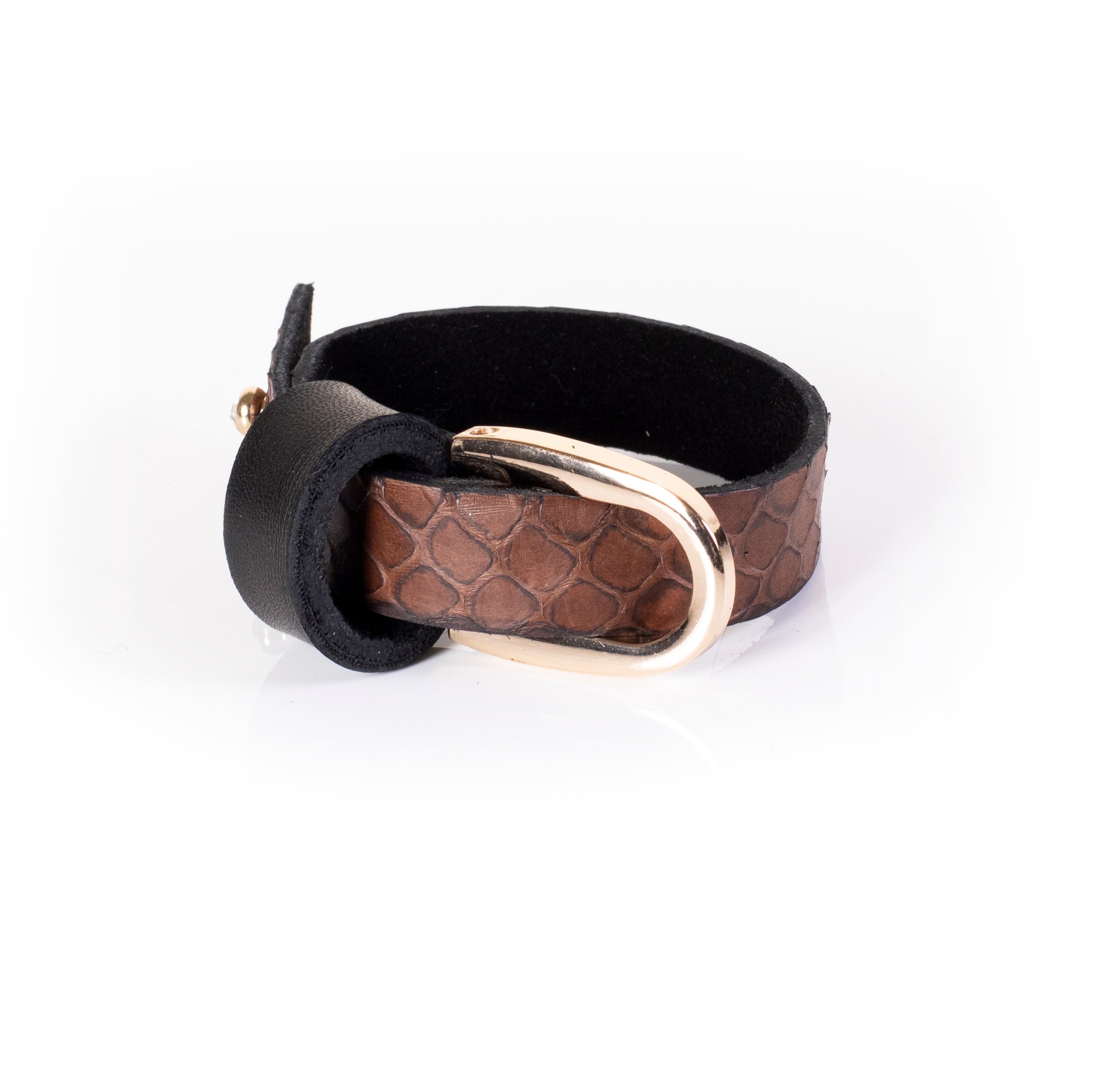 Brown textured leather cuff bracelet with black strap and gold ring detail, layered minimalist statement bracelet for women