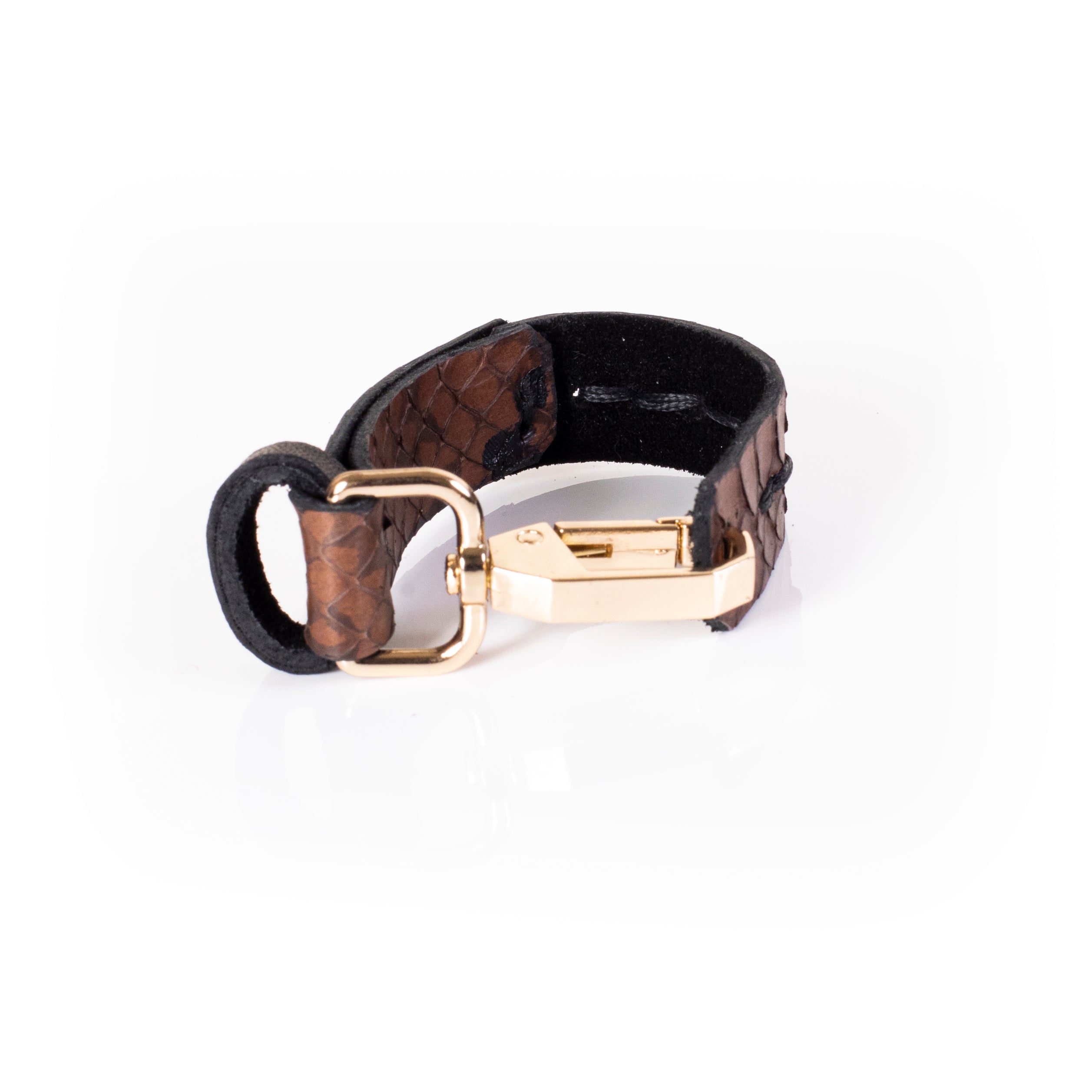 Brown textured leather cuff bracelet with vertical stitching and gold clasp, reptile pattern minimalist statement bracelet for women