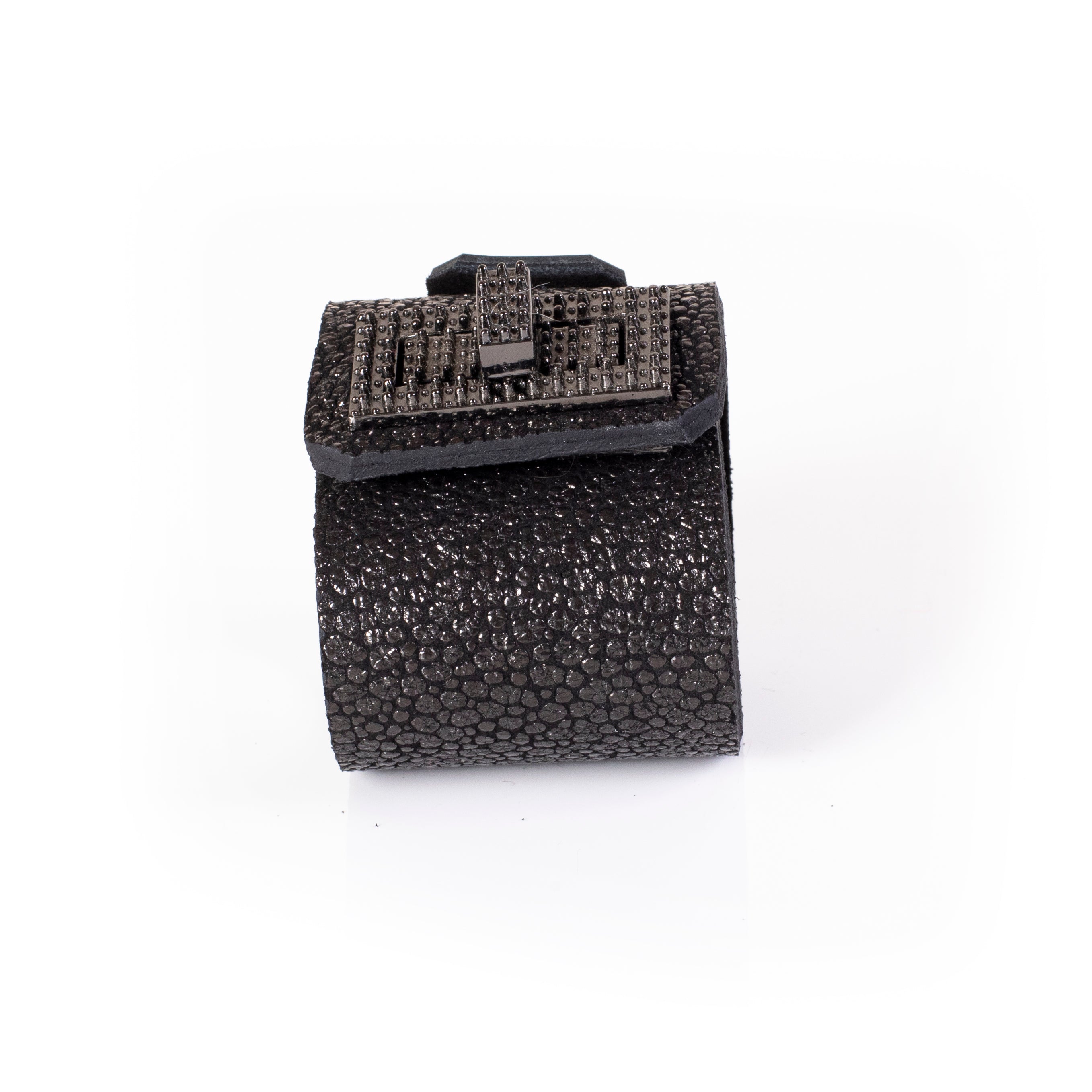 Black textured leather cuff bracelet with square studded plate and metallic clasp detail, bold statement bracelet for women
