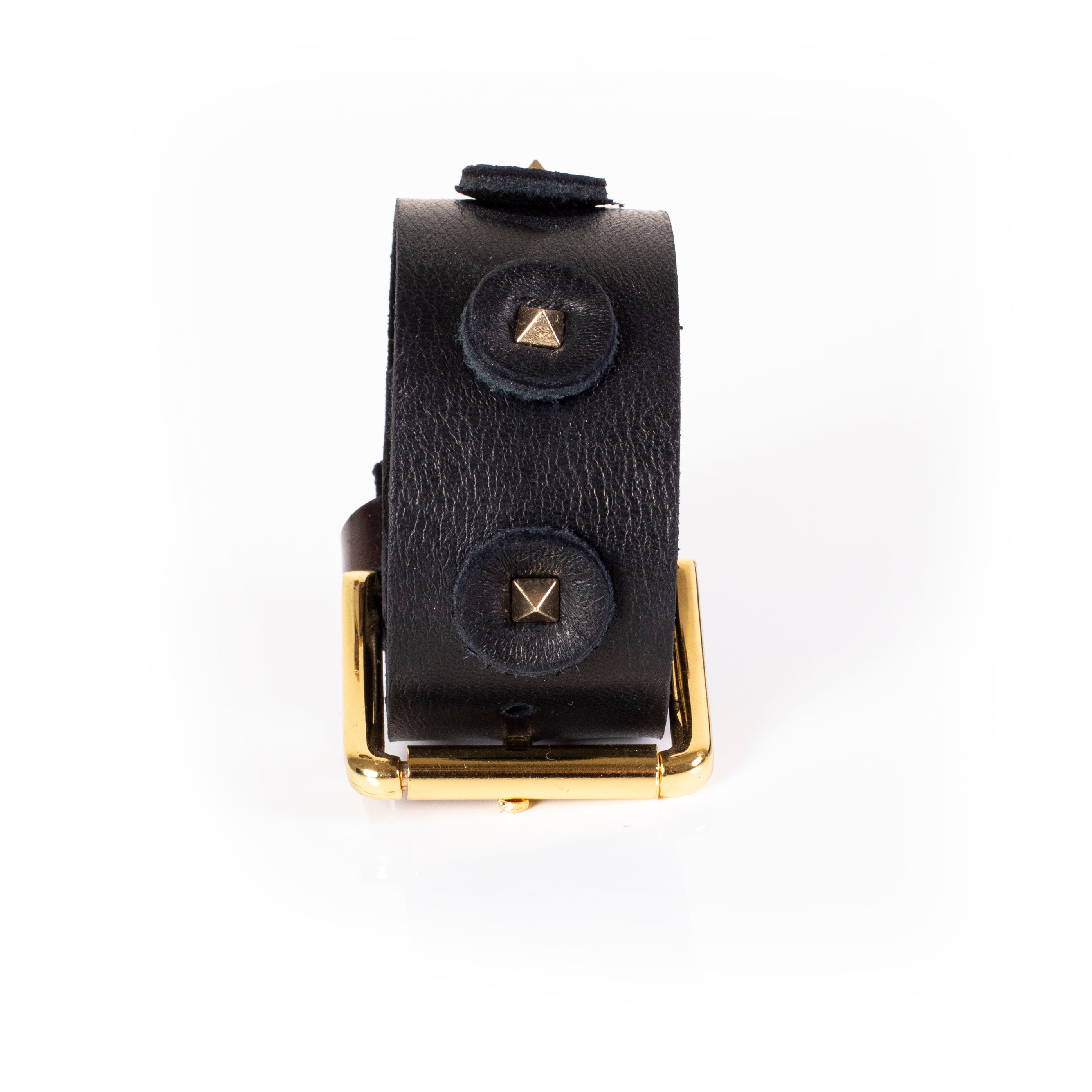 Wide black leather cuff bracelet with circular leather patches and gold pyramid studs, handcrafted statement bracelet with gold buckle for women