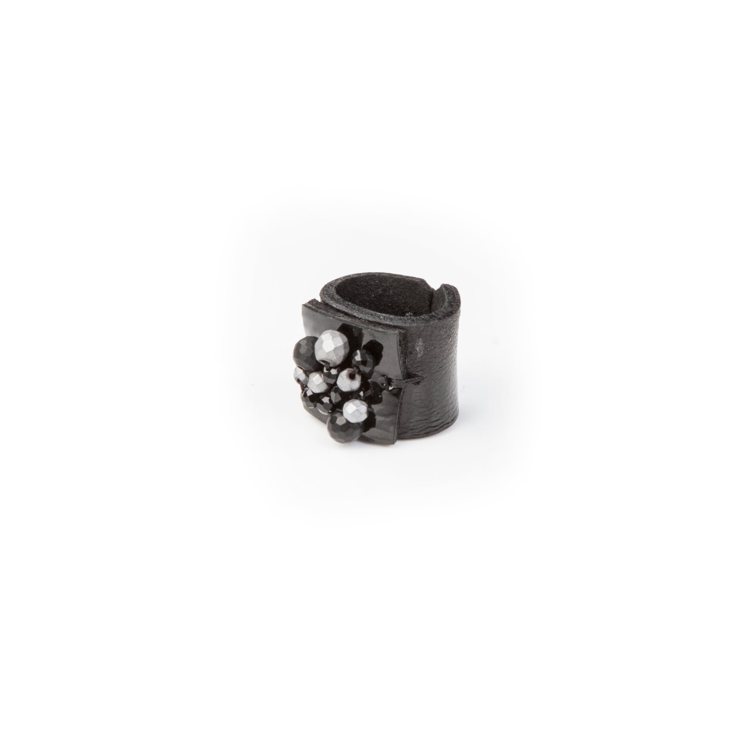 Handmade black leather statement ring with black and silver crystal cluster detail on white background